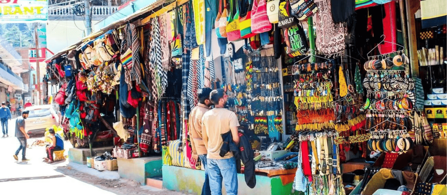 A vibrant stall in Kasol Market selling local handicrafts and hippie souvenirs.