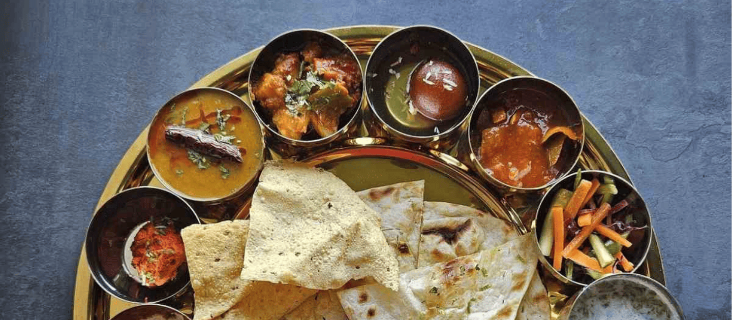 A plate of crispy Kachori Sabzi, a popular street food breakfast in Haridwar.
