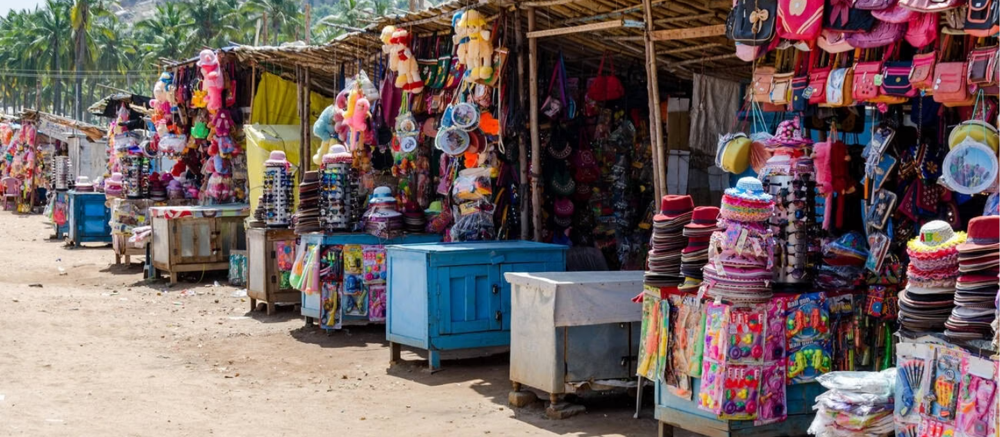 Colorful stalls in Hampi Bazaar selling local handicrafts and souvenirs.