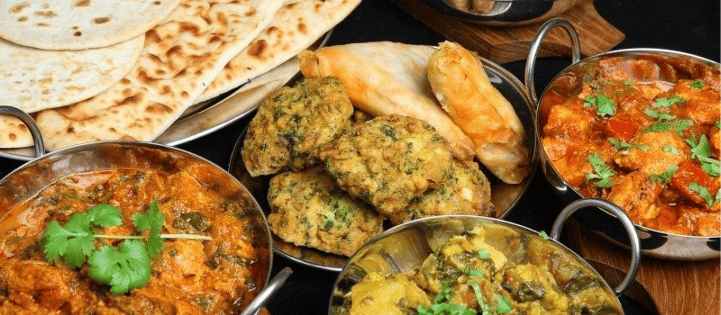 Delicious spread of authentic Kashmiri cuisine featuring traditional curries, flatbreads, and local delicacies popular in Pahalgam