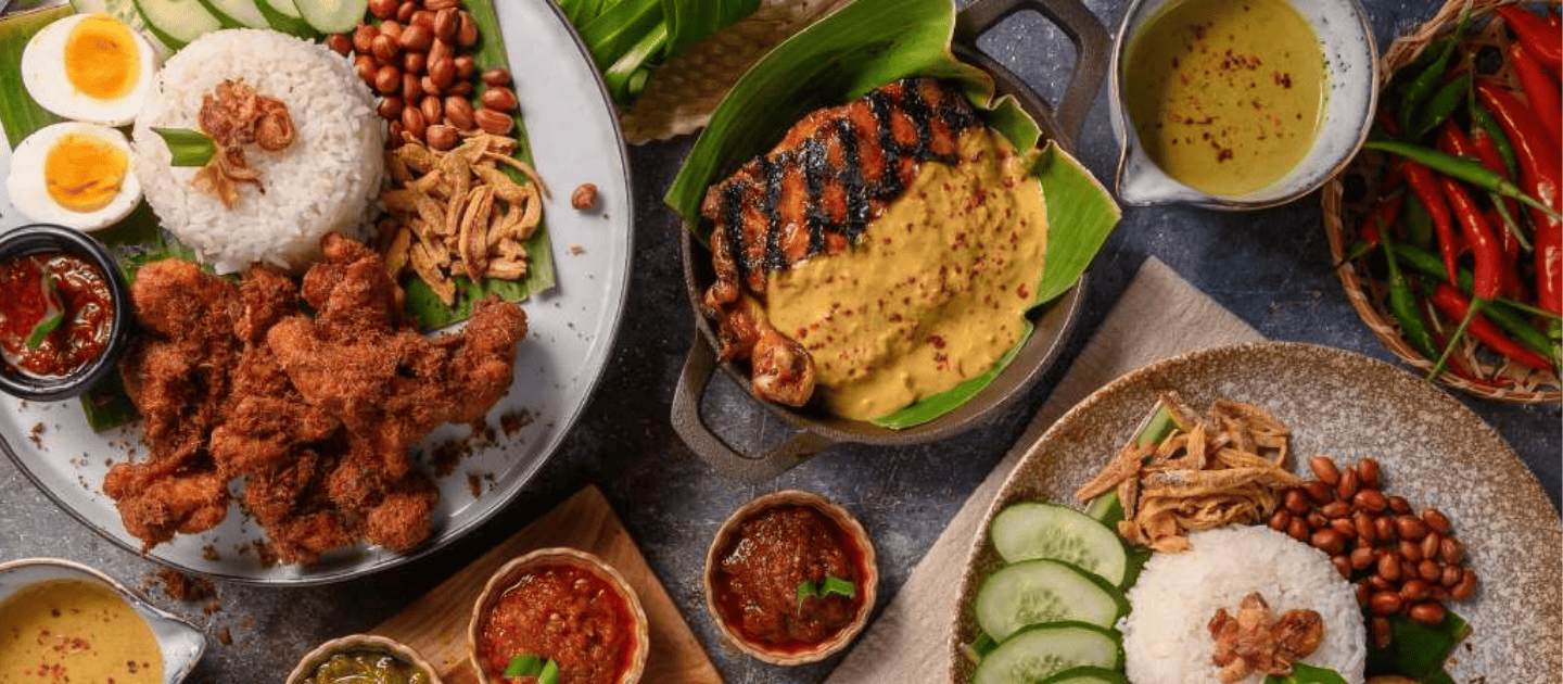 Tropical island feast spread featuring rice platters with fried seafood, peanuts, and boiled eggs, accompanied by grilled fish in yellow curry sauce and fresh red chilies