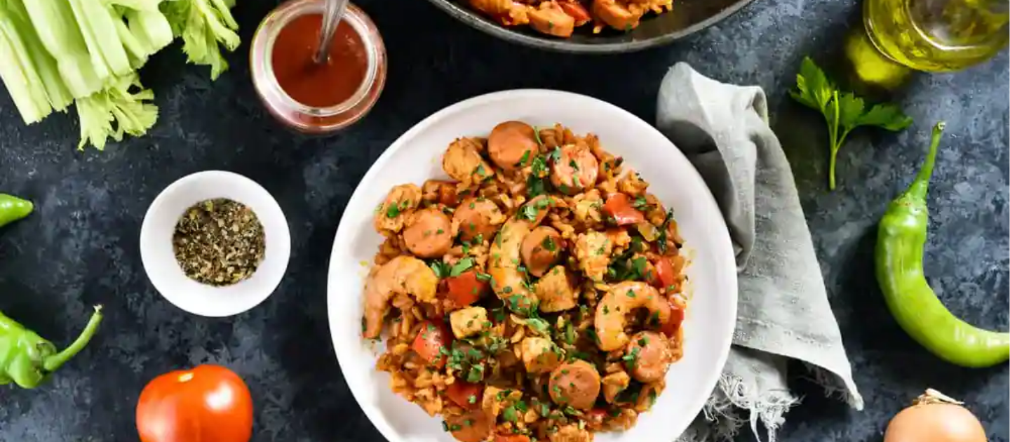 Overhead view of a hearty spicy rice and meat stir-fry dish with fresh vegetables, representing the savory local cuisine of Ziro Valley