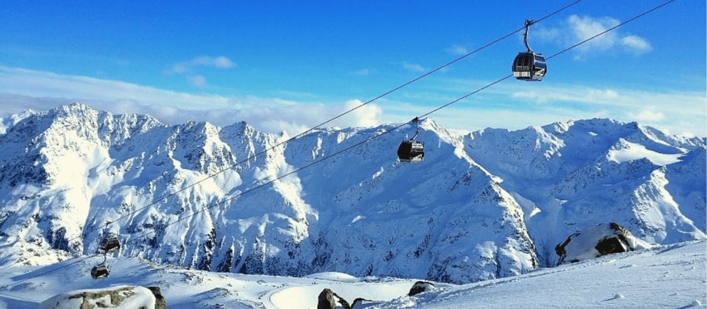 Scenic cable car gondola ride soaring over snow-covered Himalayan mountains at Patnitop, offering breathtaking panoramic views of the winter landscape in Jammu and Kashmir