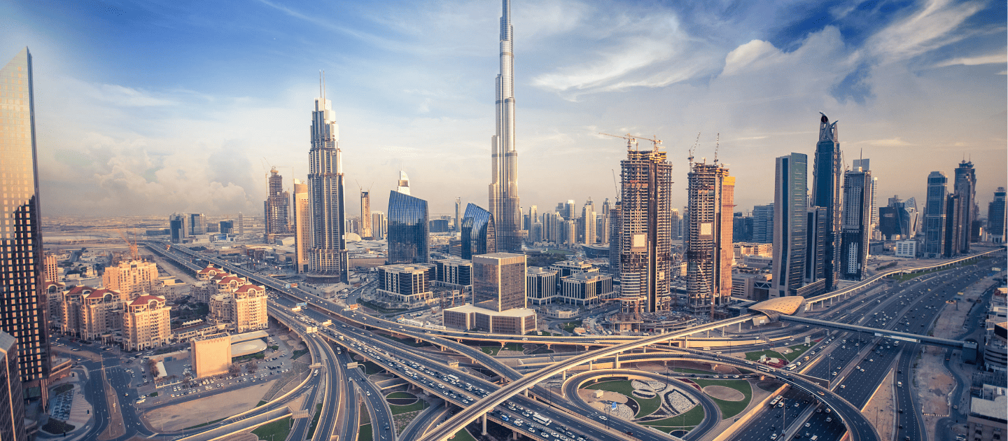 Panoramic view of the modern Dubai skyline featuring the towering Burj Khalifa and skyscrapers along busy highways