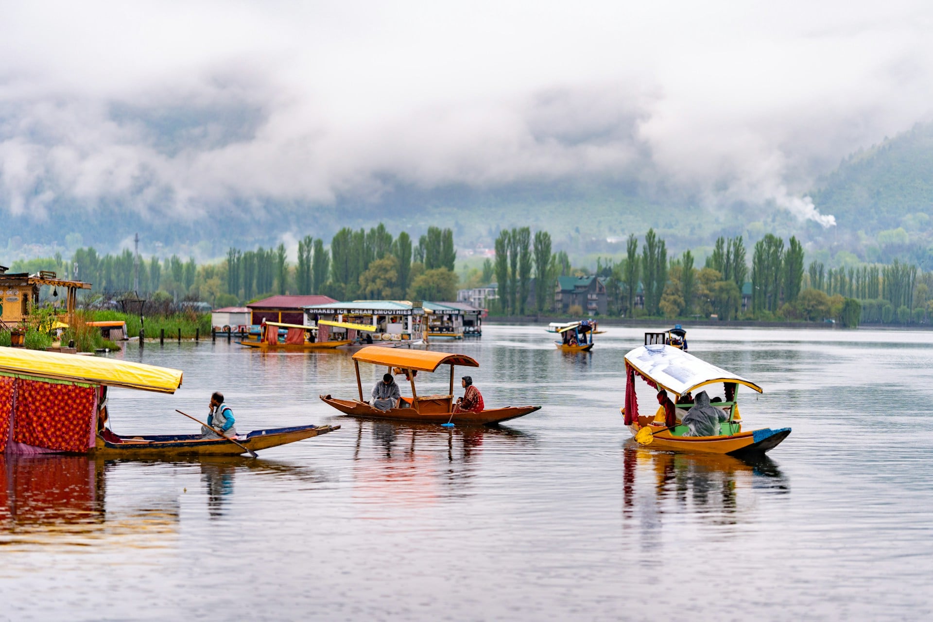 Shikara boats on Dal Lake in Srinagar Kashmir with mountains and mist Shikara boats on Dal Lake in Srinagar Kashmir with mountains and mist