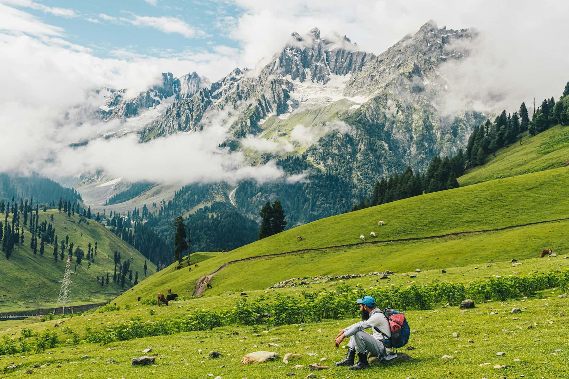Kashmir Valley Trekking View with Snow Mountains Trekking in Kashmir valley with green meadows and snow covered mountains